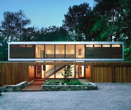 The home's all-new second level is sheathed in metal and elevated a few inches above the rebuilt cedar-clad first floor.