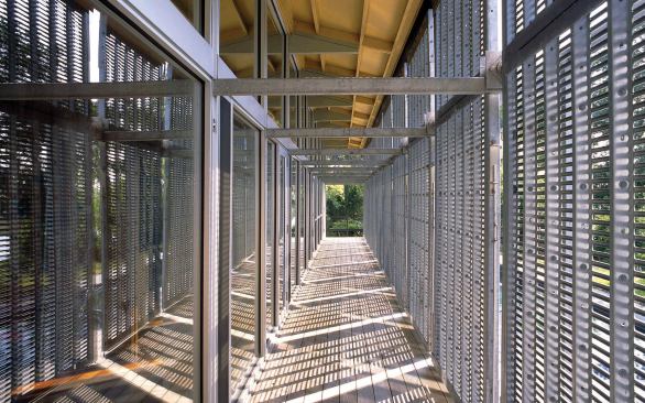 Custom metal louvers form a protective layer against the sun's rays and hurricane winds. When not in use, they rest horizontally above the back porch.