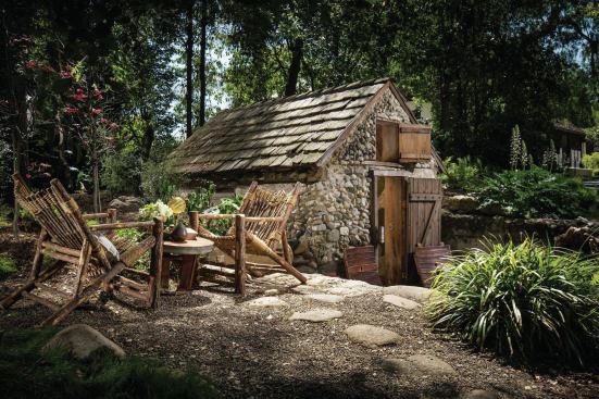 The whimsical outbuilding provides a secluded backyard getaway.