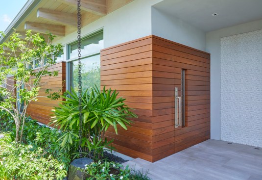 The Ipe rain-screen extends back into the entry alcove and is integrated with a 5-foot wide pivot door. The experience creates a unique sense of mystery, surprise and delight as you enter through into the expansive great room.