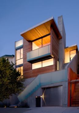 The Diamond Project by Terry Terry Architecture scales its uphill lot with grace and skill. Interiors and exteriors are unified through the use of simple materials-concrete, glass, natural wood-and clean, fuss-free detailing, creating a serene retreat from city life. Sloping roof planes echo the lot's rise.