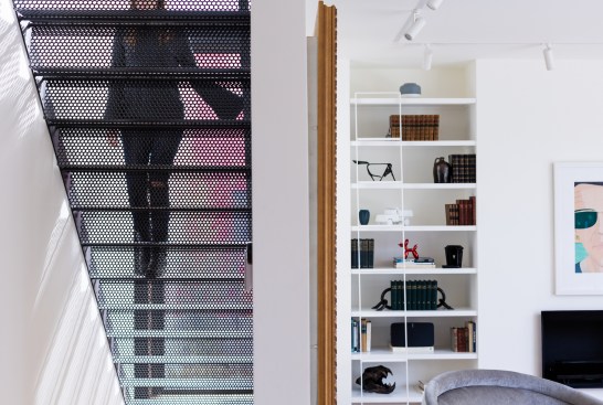 To maintain the sense of transparency in the addition, local artisans fabricated a perforated metal staircase.