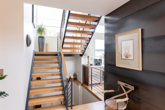 A steel and white oak staircase provides vertical circulation.