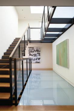 The main stair channels light through the core of the building.