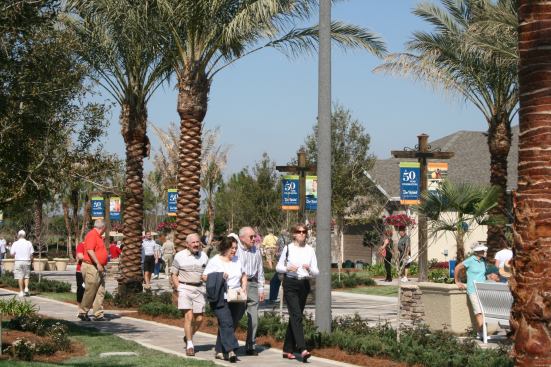 As many as 2,000 people attended the grand opening of 10 new home designs, squeezing into the crowded houses and wandering down the busy street they are built on.