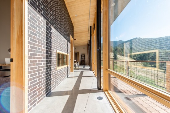 In the gallery, the sun enters the home and heats the interior brick wall and concrete floors, storing and releasing heat throughout the night.