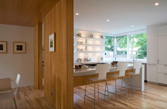 Full-height windows and partial walls allow sunlight to stream into adjacent rooms.