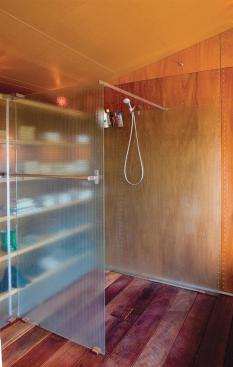 Stainless steel screws fasten the bath's plywood panels to an earthquake-resistant shear wall. The screws' tight symmetrical pattern not only meets required construction techniques, it also becomes a nifty design detail.