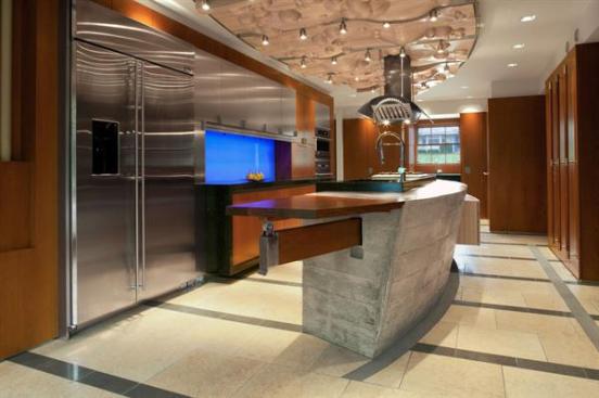 A+cast-concrete+island+with+a+fold-down+leaf+made+of+bubinga+is+the+focal+point+of+the+room.+On+the+curved+side+of+the+island+is+a+maple+cabinet+for+storing+table+linens.+The+cabinet+is+wheelchair+accessible.