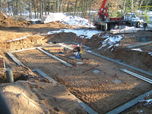 Workers prepare the footings.