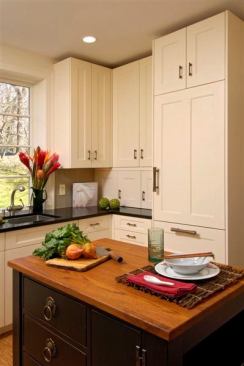 This mid- to high-range has a clean and simple Asian feel with white cabinets. The black island is topped with a teak countertop and enhanced Asian-style hardware.&nbsp;