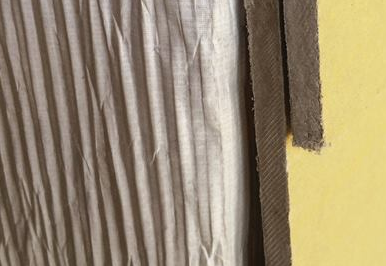 The textured surface on this housewrap, made by Tyvek, creates small vertical channels between the back of the cladding and the sheathing, allowing moisture to drain to the ground. It needs to be oriented properly when installed.