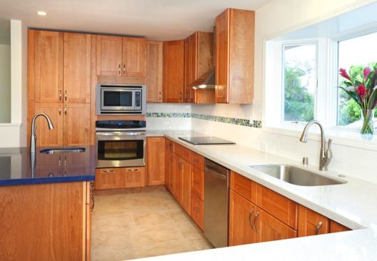 Kenmore appliances, Pergo laminate flooring, Silestone quartz countertops, and off-the-shelf faucets helped keep costs down in the new kitchen.
