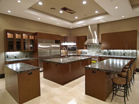 The house's kitchen includes ample prep surfaces and eating areas.