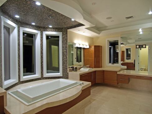 A soaking tub is the centerpiece of the master bathroom, which also incorporates a two-person walk-in shower, walk-in closet, and safe room.