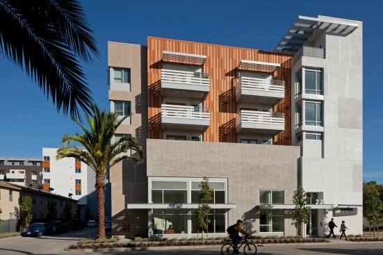 The Annex building features fiber-cement siding painted in random colors to resemble old boards. It sits closer to the ocean and is designed to feel like giant beach house; the stair tower and sunshade suggest a lifeguard tower.