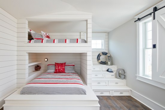 Oursler designed the custom-built bunk room with a queen and full bed, storage in the bunk stairs, and a barn door window treatment.