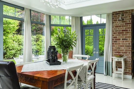 VistaGrande® Flush-Glazed Smooth with Clear Glass and SDLs - Blend the outside and in: exposed brick walls contrast beautifully with scenic, oversized windows and flush-glazed patio doors like the VistaGrande®.