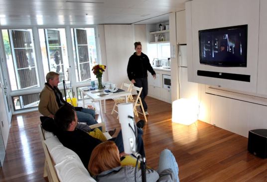 The open floor plan of the home’s interior is designed to sell Ohioans on the concepts of flexible space. Among the room's modular features are a table, chairs, and a couch that fold up to slide into slots in the entertainment unit.