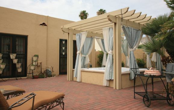 Keeping It Eclectic: This Phoenix, Ariz. spa features a stucco ramada to match the historic home.
