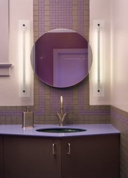 Beautiful lighting fixtures don’t always need to be fancy. This custom appointment was made from reclaimed glass found in an old medicine cabinet, a used compact disk, kitchen cabinet pulls, and other odds and ends. But humble materials aside, its simple design offers white light on both sides of the vanity while the design fits in perfectly with the bathroom’s Art Deco d&eacute;cor. Architect: Randall Comfort, St. Louis Builder: ARC works, St. Louis