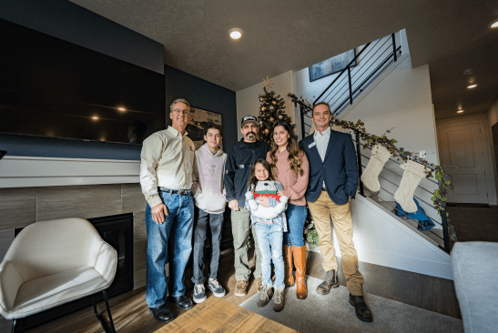 U.S. Marine Corps Sergeant Jason Plank and his family (middle) were surprised Wednesday morning with the news they are receiving a new mortgage-free home in Meridian, Idaho, from Operation Finally Home and Lennar. Joining the Plank family are Rusty Carroll, Executive Director, Operation Finally Home (left) and Jeff Clemens, Boise Lennar Division President (right).
