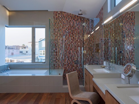 The same mosaic pattern runs throughout this modern beach home and gives life to a white bath.&nbsp;Project: Silver Strand Beach House by Robert Kerr Architecture Design, Inc. &nbsp;