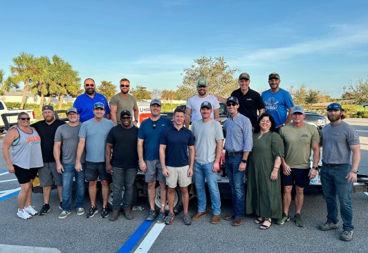 CEO Ryan Marshall (fourth from right) with a volunteer-led supply caravan. Volunteers worked to deliver essential items like generators, fuel, water, and more to impacted PulteGroup divisions.