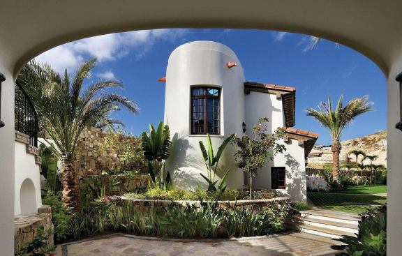 Traditional architectural details and tropical landscaping give the home a genuine sense of place. 