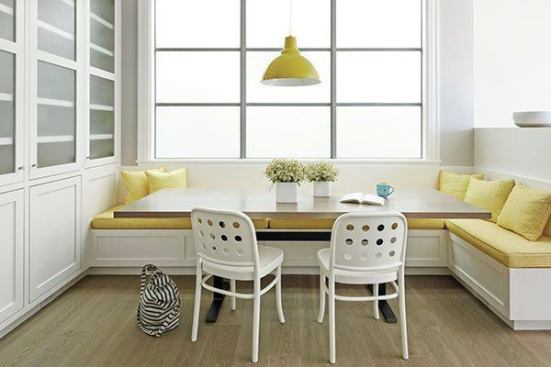 The breakfast area. One way to connect the modern with the more traditional front of the home was to use crafted woodwork for paneling on the built-ins and below the banquette seating, for example. Other touches include wainscoting in the entry and dining room. 