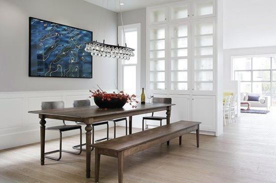 The dining room, near the front of the house, offers an open view toward the breakfast nook and family room in the rear. The interior design was done by Lisa Lougee Interiors.