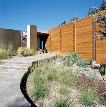 As with many of the firm&Otilde;s houses, the quiet front elevation of this La Jolla, Calif., residence (below, left) gives way to a dramatic rear fa?ade (left and below). Clerestory windows let sunlight spill into the interiors.