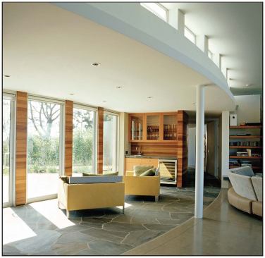 As with many of the firm’s houses, the quiet front elevation of this La Jolla, Calif., residence (below, left) gives way to a dramatic rear fa&ccedil;ade (left and below). Clerestory windows let sunlight spill into the interiors.