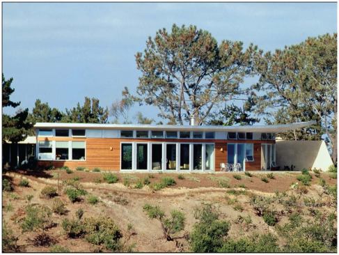 As with many of the firm’s houses, the quiet front elevation of this La Jolla, Calif., residence (below, left) gives way to a dramatic rear fa&ccedil;ade (left and below). Clerestory windows let sunlight spill into the interiors.