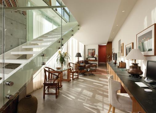 The media room and home office is long and narrow, but it’s filled with light. Cabinetry underscores the linear plan.
