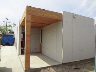 The house was finished with recycled fibre boards and wood. The house is in South Central LA, and there's even a Facebook discussion thread amongst the neighbors about how happy they are about the change in the 'hood.

