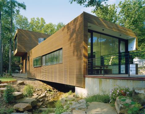 Residential Architect  2010 RADA  L-Stack House, Fayetteville, Ark.  Grand Award / Custom, 3,000 Square Feet or Less  Marlon Blackwell Architect, Fayetteville    The first floor of Marlon and Meryati Blackwell’s own house sits atop concrete piers, the better to span a creek on the property.