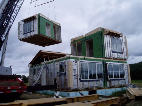 From order to delivery, a modular house like this one would take about six months. Built with volunteers, this one took eight months.Here, modular boxes are set on the home's foundation.

