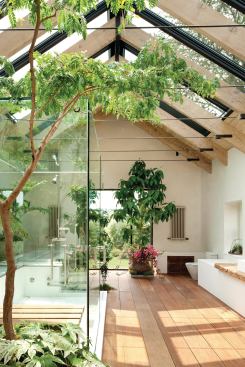 A ridge skylight floods the master bath with light. Sunlight plays up the soft finishes of salvaged and found materials.