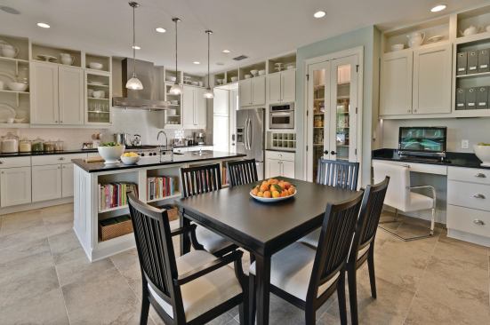 Holidays at Home A small house can accommodate big gatherings if it's designed right. This kitchen has everything a cook needs to prepare a feast for a large group, including a KitchenAid six-burner gas range with double ovens, LED can and pendant lights for task lighting, and a Kohler farmhouse sink that's big enough to wash a Thanksgiving turkey. Open shelves by Merillat provide display space for items that aren't used every day.