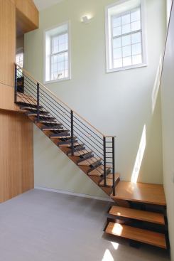 The most important architectural decisions were subtractive, the designer says. Here, Eisner removed a portion of the first floor to create a double-height atrium space. The double-sided/double-height bamboo paneled wall acts as a new vertical focal point to what was a generic house layout.