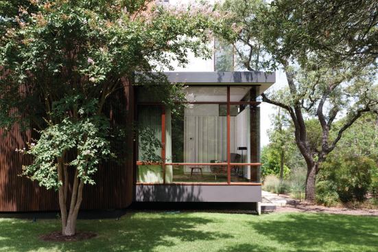 The new home replaces an old one. In order to save the mature live oak trees on the property line, the architects followed the foundation line of the original home. 
