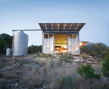 Mod Cott RADA 2010 – Custom Home 3,000 Square Feet or Less / Grand Award  Architect: Mell Lawrence Architects, Austin, Texas; Builder: Classic Constructors, Marble Falls, Texas; Photography: Mell Lawrence This Texas guesthouse and weekend retreat juxtaposes rough-edged elements and polished precision. Big glass doors and an overhang of solar panels make up the front elevation.