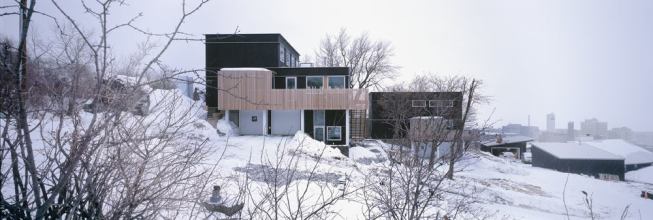 The black siding, used as a skateboard surface in parks, is made of recycled paper and resin.