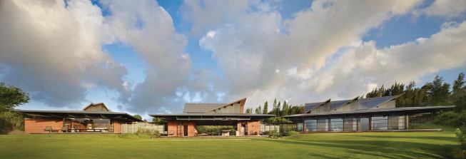 Traditional Hawaiian buildings inspired the home's corrugated metal roofs, which are tailored to the site's wind patterns.