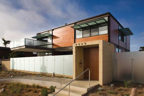 A covered entry pavilion provides a dramatic transition from the street to the house.