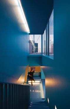 A blue-saturated stairwell in a downtown Omaha, Neb., penthouse heightens the experience of moving upward toward the sky.