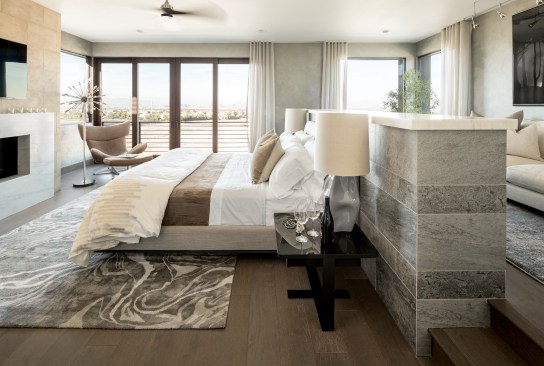 Down Time Although it’s an entertainer’s dream house, the 2015 New American Home makes room for quiet time, too. To give the owners a place to relax, the second-floor master bedroom is set off from the public area by a catwalk. Inside, a pony wall divides the expansive sleeping area from an intimate raised sitting room.