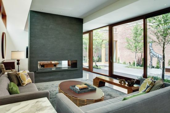 The living room’s fireplace is surfaced in Indian black granite.