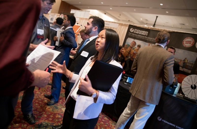 Jennifer Willard, a first-year student at the Myers-Lawson School of Construction, speaks with recruiters from Scott Long Construction during the fall career fair at the Inn at Virginia Tech.